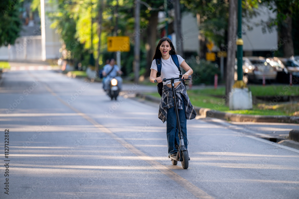 Obraz premium A woman is riding a scooter down a street