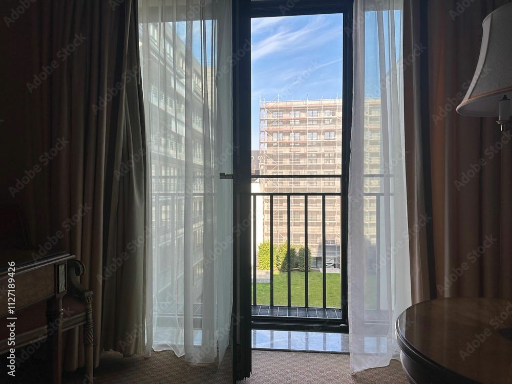 Fototapeta premium View on hotel garden through open balcony door