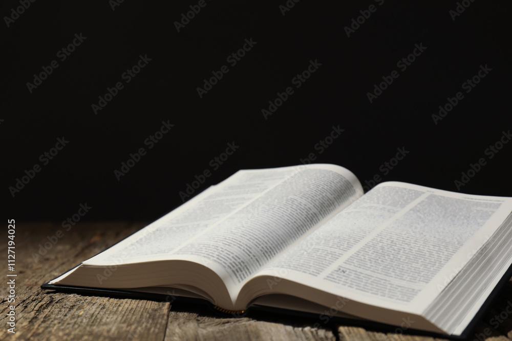 Open Holy Bible in English language on wooden table. Space for text Open Holy Bible in English language on wooden table. Space for text