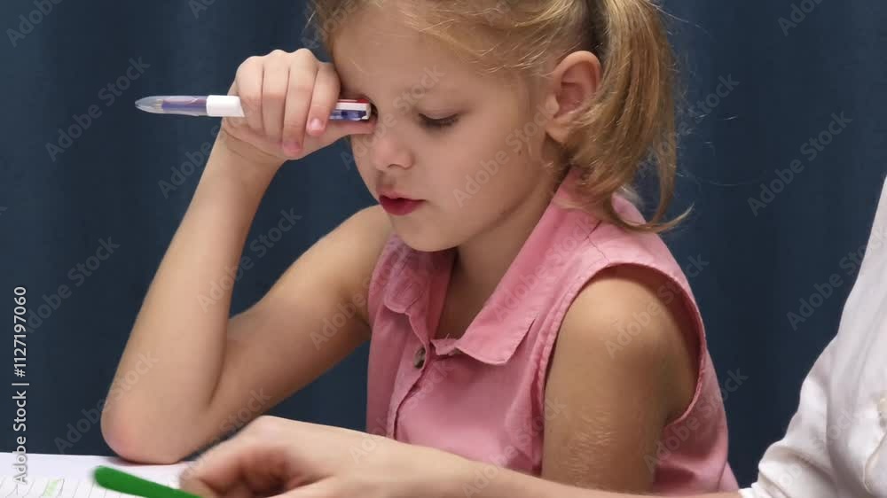 A mother supports her daughter with homework A mother supports her daughter with homework