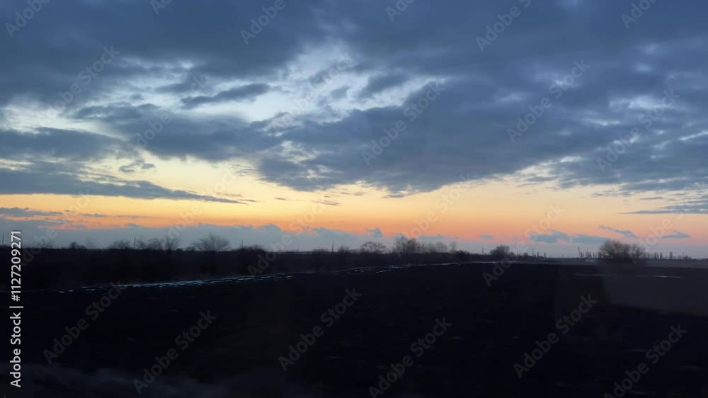 Beautiful sandy field with blue sky and fast moving clouds. Tropical beach with waves crashing on an empty field. Dramatic Time Lapse Sunset over Storm Clouds. Beautiful sandy field with blue sky and fast moving clouds. Tropical beach with waves crashing on an empty field. Dramatic Time Lapse Sunset over Storm Clouds.