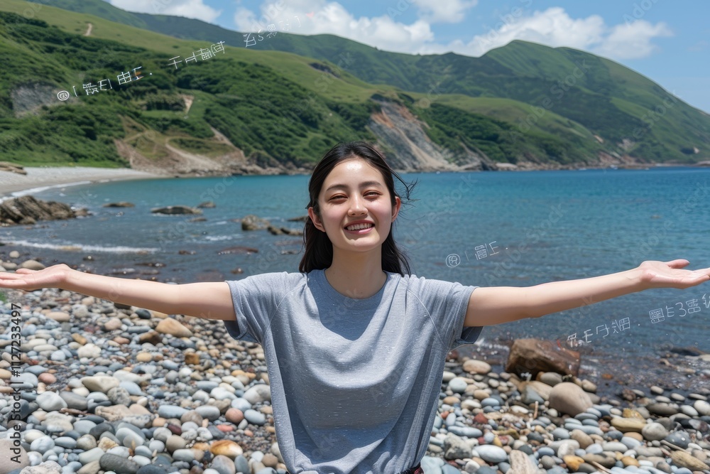 Woman joyfully embracing the fresh ocean breeze with arms outstretched on a beautiful rocky beach Woman joyfully embracing the fresh ocean breeze with arms outstretched on a beautiful rocky beach