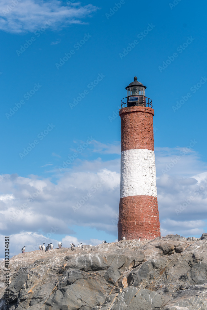 Les Eclaireurs lighthouse on rocky island with snowy mountains in Beagle Channel Les Eclaireurs lighthouse on rocky island with snowy mountains in Beagle Channel