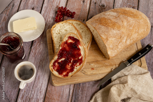 Colazione all'italiana con pane, burro e marmellata. Non può mancare una tazza di caffè. photo