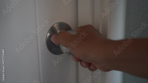 Use your hand to open the bedroom door knob.