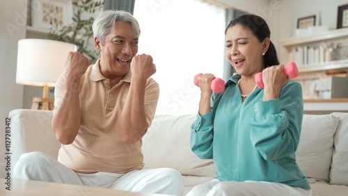 Canvastavla Happy elderly couple exercising together with dumbbells at home, focusing on muscle strength, joint health, and physical wellness for improved mobility and healthy aging