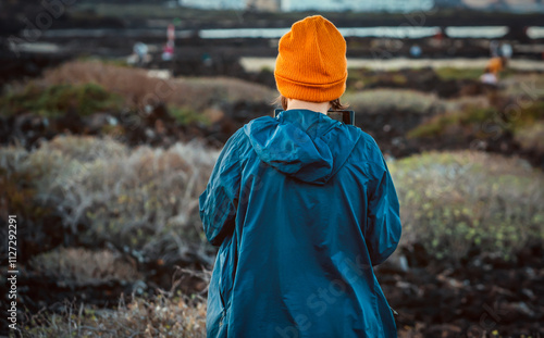 A girl travels and flights a drone, holds a remote control in her hands. photo