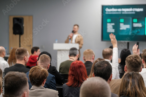 Photos Focused audience listens to speaker during seminar