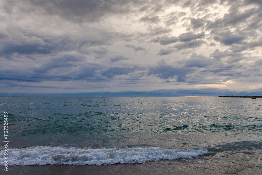 Sandy shore of sea against the sky in overcast morning Sandy shore of sea against the sky in overcast morning