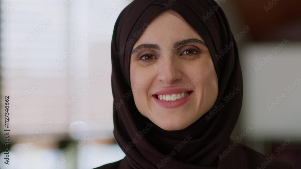 Happy joyful Muslim businesswoman portrait arabic islamic woman in black hijab girl female business lady turning head looking at camera healthy dental toothy smile beauty Islam Arabian face indoors Happy joyful Muslim businesswoman portrait arabic islamic woman in black hijab girl female business lady turning head looking at camera healthy dental toothy smile beauty Islam Arabian face indoors