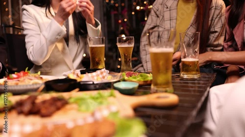 Group of friends clinking glasses in celebration at night, Happy group of friends having celebration and drinking dinner party at night, Holiday, Festival celebration.