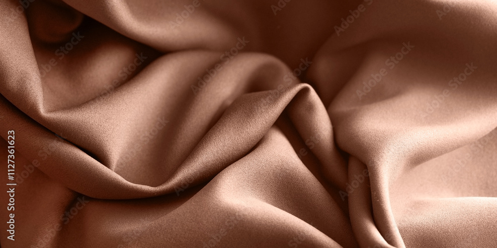Obraz premium Demonstrating the colors of 2025 - Mocha Mousse. Close-up of a textile abstract background made of delicate material with waves and soft folds. Banner, copy space