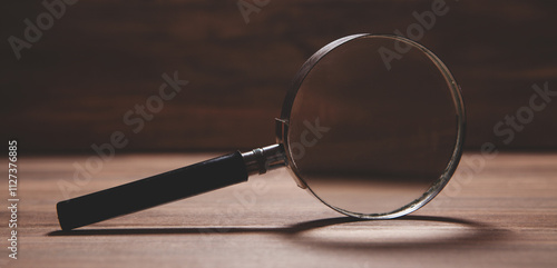 magnifying glass on wooden table background