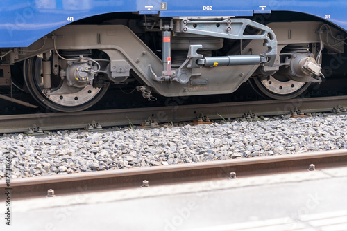 Fotografija Closeup of a pivoted bogie of a train on the tracks