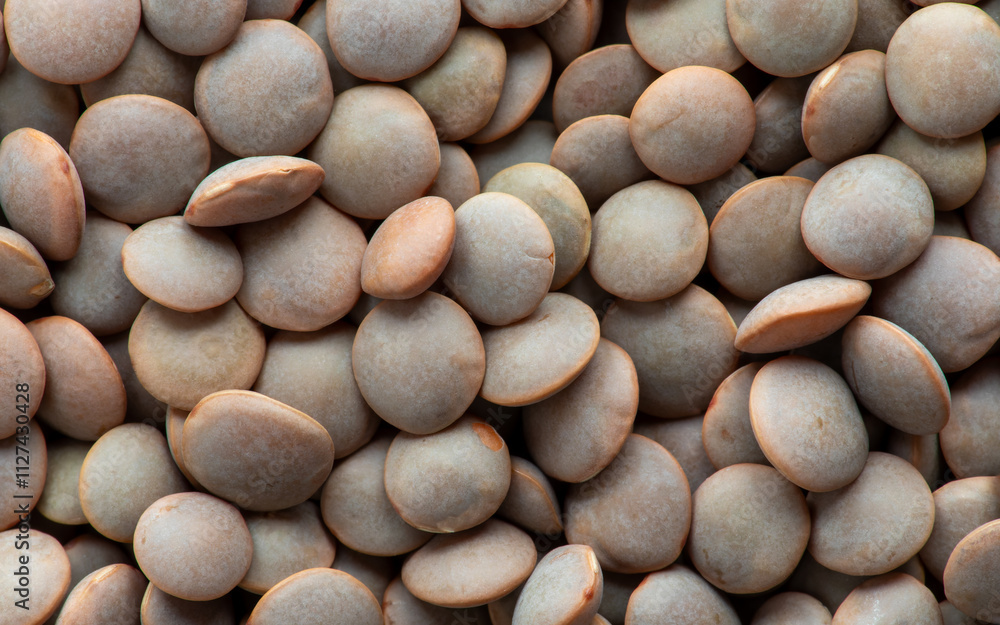 Uncooked brown lentils as an background texture. Uncooked brown lentils as an background texture.