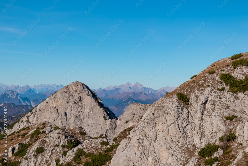 Summit of mount Due Pizzi Cima Alta surrounded by rugged mountain peaks of Carnic and Julian Alps. Hiking trail to mount Piper in Friuli Venezia Giulia, Italy. Wanderlust Italian Alps on blue sky day Summit of mount Due Pizzi Cima Alta surrounded by rugged mountain peaks of Carnic and Julian Alps. Hiking trail to mount Piper in Friuli Venezia Giulia, Italy. Wanderlust Italian Alps on blue sky day