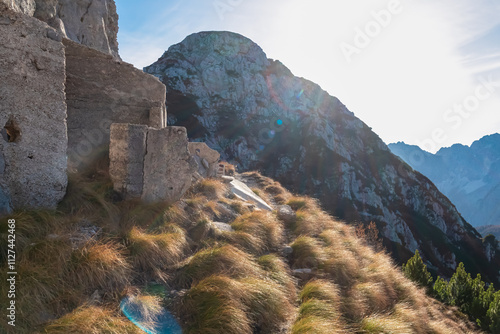 Scenic hiking trail to mount Piper along remains of world war one ruins embedded in massive rock formation of majestic ridges of Julian Alps, Friuli Venezia Giulia, Italy. Wanderlust in Italian Alps photo