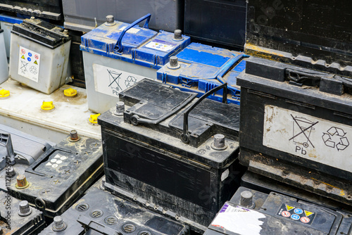 Stack of many used car lead batteries for recycling in a hazardous waste facility photo