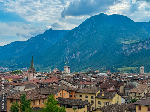 Scenic view of old town of Trento seen from Loggia Veneziana in castle Museo Castello del Buonconsiglio, Trentino Alto Adige, Italy. Surrounded by majestic Dolomites mountains. Cityscape in summer photo