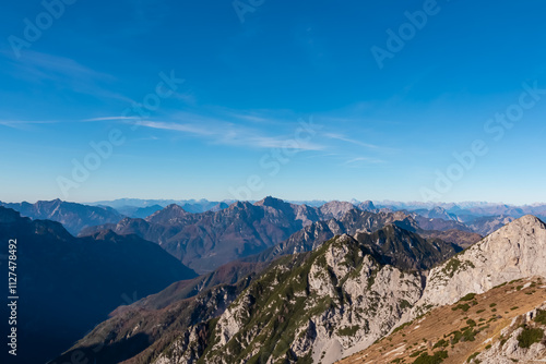 Summit of mount Due Pizzi Cima Alta surrounded by rugged mountain peaks of Dolomites, Carnic Alps and Julian Alps. Hiking trail to mount Piper in Friuli Venezia Giulia, Italy. Wanderlust Italian Alps