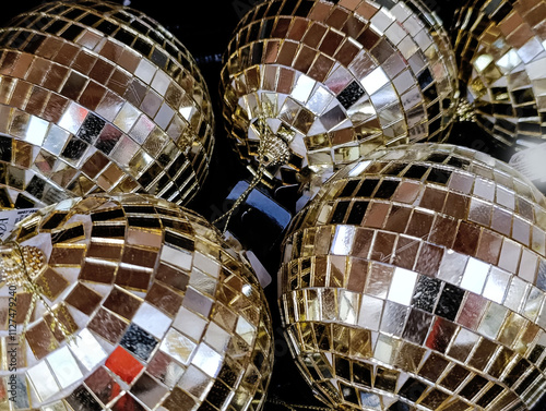 Golden Christmas balls in a box, top view, close-up