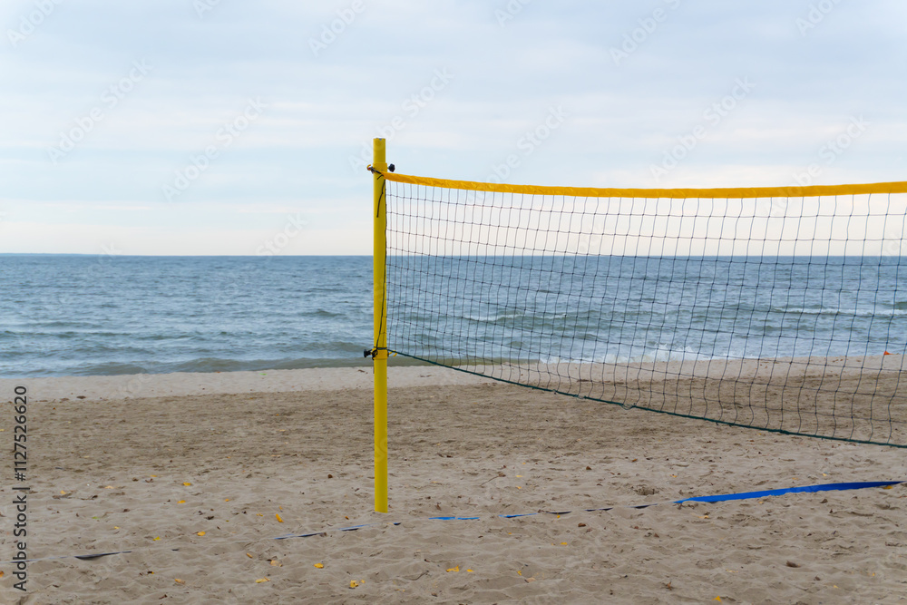 A small volleyball court with a net, surrounded by soft sand and washed by gentle waves. This spot combines the tranquility of the sea with the energy of sports. A small volleyball court with a net, surrounded by soft sand and washed by gentle waves. This spot combines the tranquility of the sea with the energy of sports.
