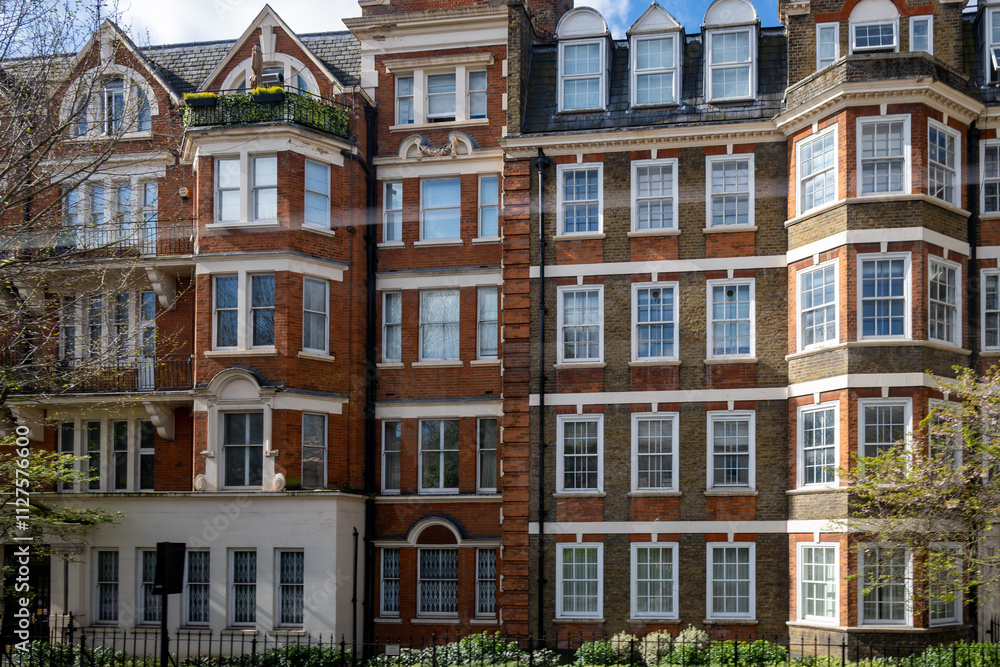 Obraz premium Red bricks houses on Hans Crescent street in Royal Borough of Kensington and Chelsea, London, UK