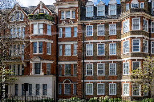 Red bricks houses on Hans Crescent street in Royal Borough of Kensington and Chelsea, London, UK