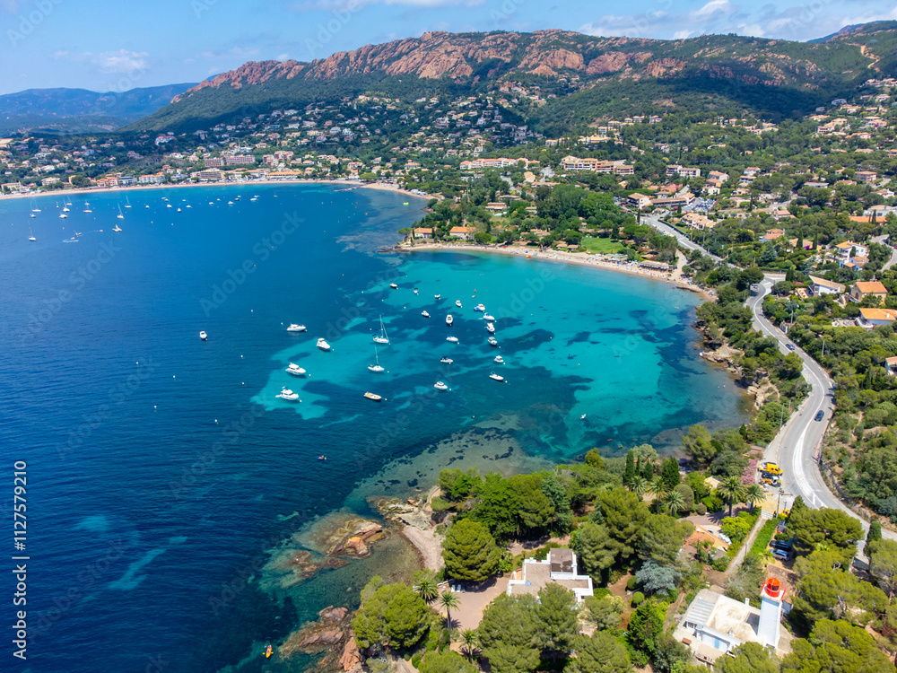 Naklejka premium Panoramic view from above on blue Mediterranean dea, sandy beach of Agay town, summer vacation destination near Esterel mountains, French Riviera, Provence. France