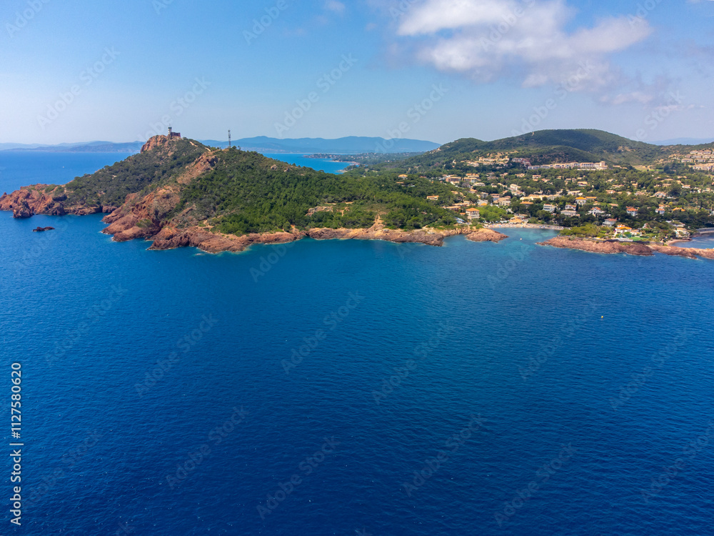 Panoramic view from above on blue Mediterranean dea, sandy beach of Agay town, summer vacation destination near Esterel mountains, French Riviera, Provence. France Panoramic view from above on blue Mediterranean dea, sandy beach of Agay town, summer vacation destination near Esterel mountains, French Riviera, Provence. France