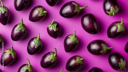 Eggplants arranged on a vibrant pink background