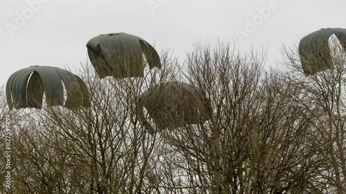 large CDS container floats to ground under massive parachutes from an Airbus A400M drop