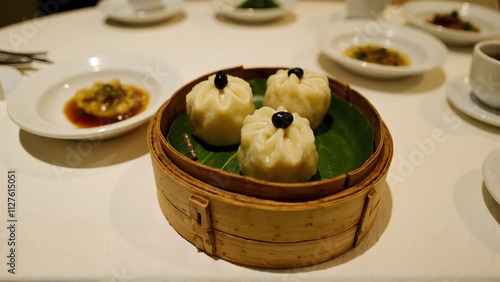 Delicious Steamed Dumplings in Bamboo Steamer photo