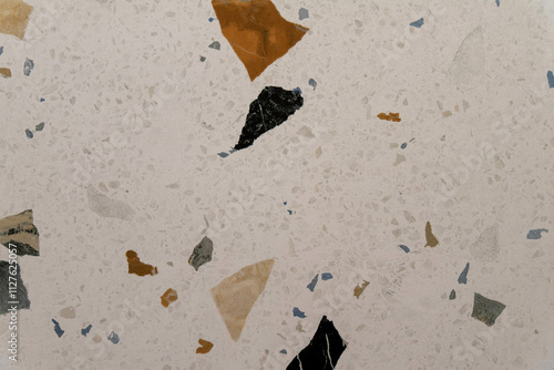 Close up of gray terrazzo texture featuring varied speckles and colors for use in decor photo