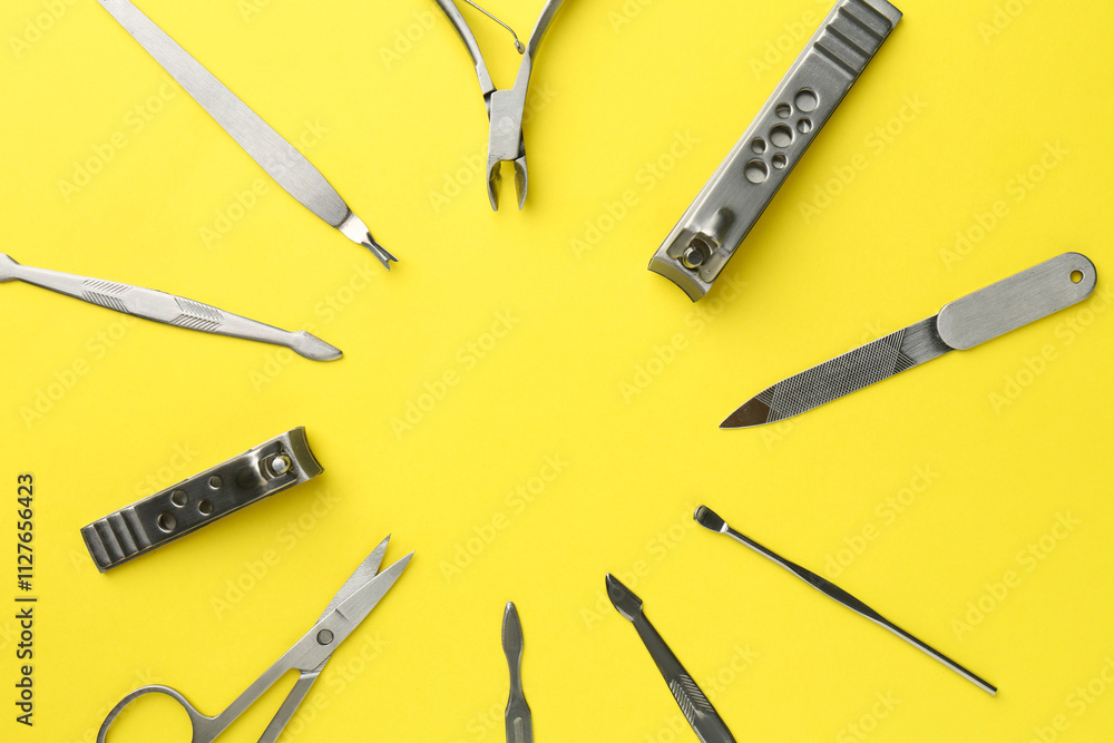 Frame of pedicure tools on yellow background, flat lay. Space for text Frame of pedicure tools on yellow background, flat lay. Space for text