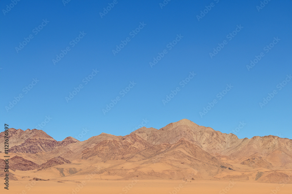 A clear blue sky. A deserted mountain with blue sky and desert. A mountain with blue sky and yellow sand. A mountain with blue sky and yellow lifestyle sand. A clear blue sky. A deserted mountain with blue sky and desert. A mountain with blue sky and yellow sand. A mountain with blue sky and yellow lifestyle sand.