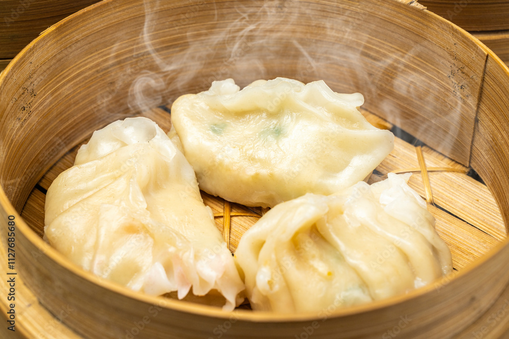 Chinese dim sum dumpling on bamboo wooden basket bowl on wooden table Chinese dim sum dumpling on bamboo wooden basket bowl on wooden table