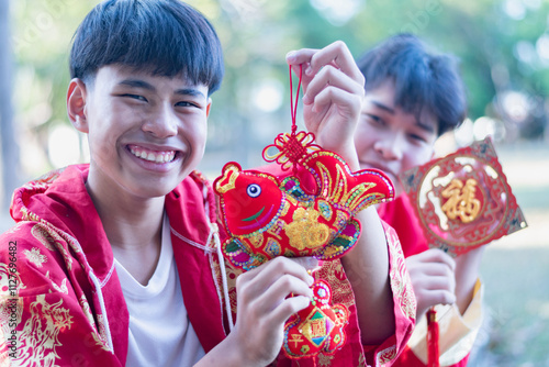 Chinese youths hold red carp lantern and Chinese greeting cards meant to wish happiness on the occasion of the annual Chinese New Year. photo