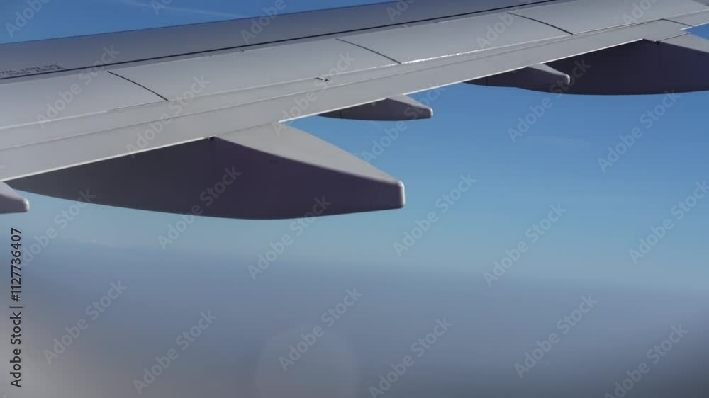 Top bird eye View from passenger porthole of beautiful landscape Flying airplane engine wing of plane fly on sunny cloudy day in winter. Transport, tourism, travel, flight, holidays vacation concept. Top bird eye View from passenger porthole of beautiful landscape Flying airplane engine wing of plane fly on sunny cloudy day in winter. Transport, tourism, travel, flight, holidays vacation concept.