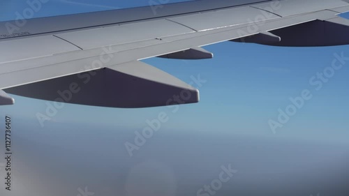 Top bird eye View from passenger porthole of beautiful landscape Flying airplane engine wing of plane fly on sunny cloudy day in winter. Transport, tourism, travel, flight, holidays vacation concept.
