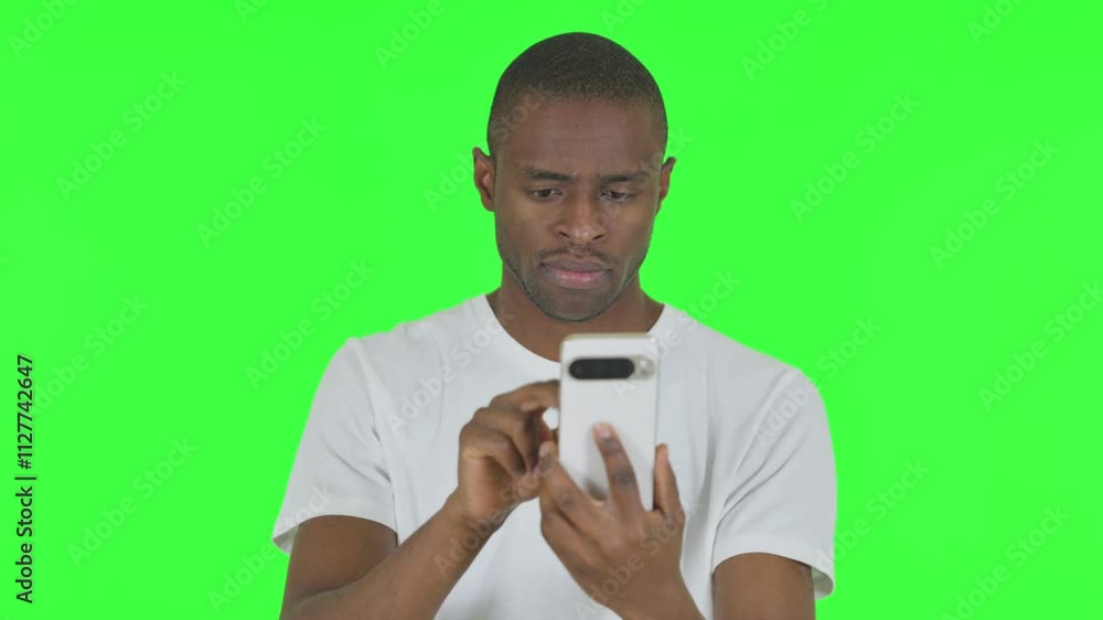 Portrait of African Man using Phone on Green Background Portrait of African Man using Phone on Green Background