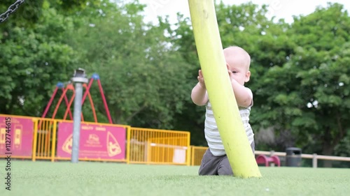 Happy family having picnic. Little Baby is crawling on green grass. Summer in park. Siblings children Playing in green park. Family fun and joy in Playgroung. Active son crawls barefoot in the field