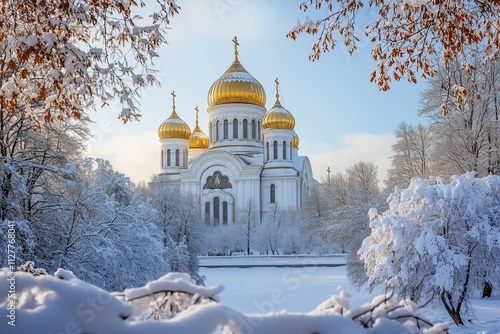A picturesque view of the Cathedral of Christ the Saviour surrounded by snow-covered trees, its golden domes shining under a clear winter sky
