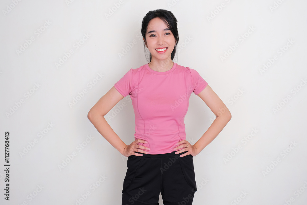 A woman wearing sportswear smiling confident with hands on waist A woman wearing sportswear smiling confident with hands on waist