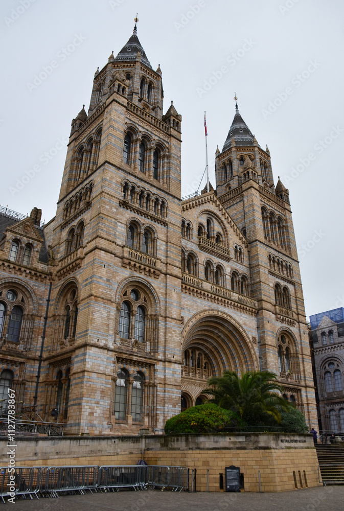 Fototapeta premium London, England, United Kingdom - October 2024: Exterior of Natural History Museum in London with blue sky and clouds autumn or fall