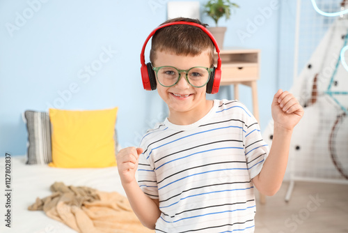 Cute little boy with headph...