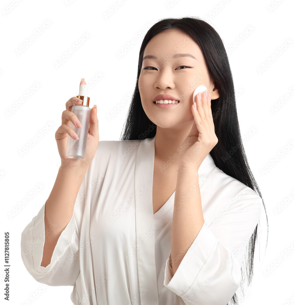 Young Asian woman with bottle of skincare product and cotton pad on white background Young Asian woman with bottle of skincare product and cotton pad on white background