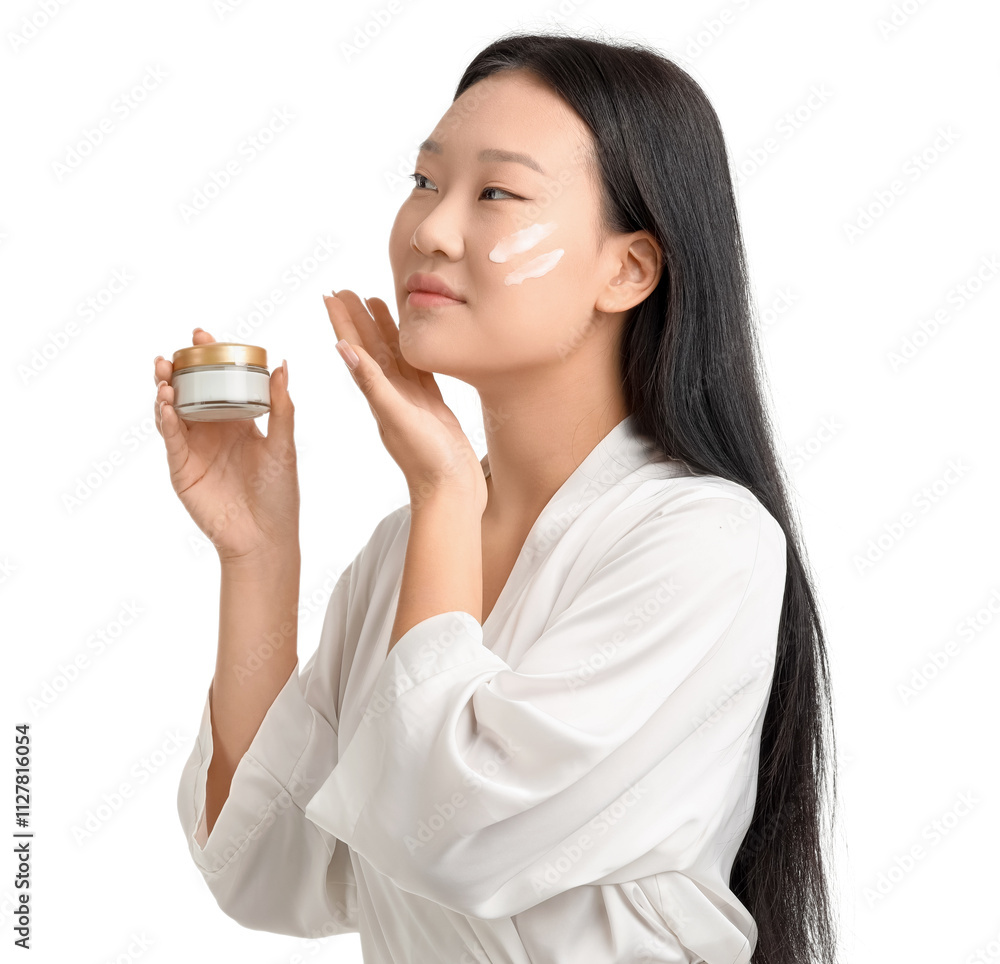 Young Asian woman applying facial cream on white background Young Asian woman applying facial cream on white background