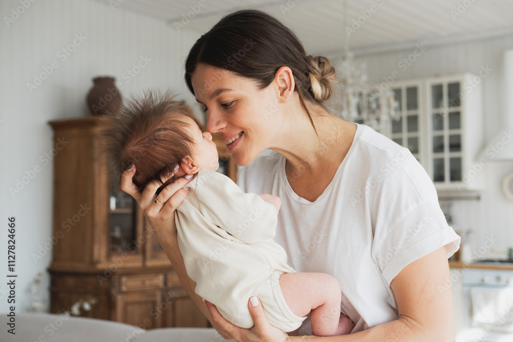 Loving mom carying of her newborn baby at home. Loving mom carying of her newborn baby at home.