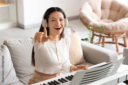 Happy young woman wearing h...
